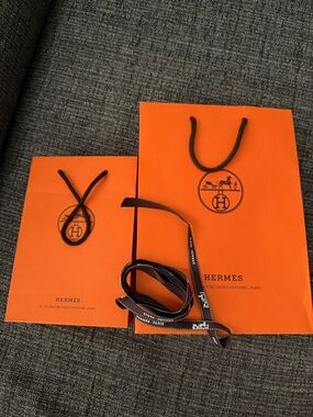 Hermès Vibrant Orange Bags with Black Accents and ribbon